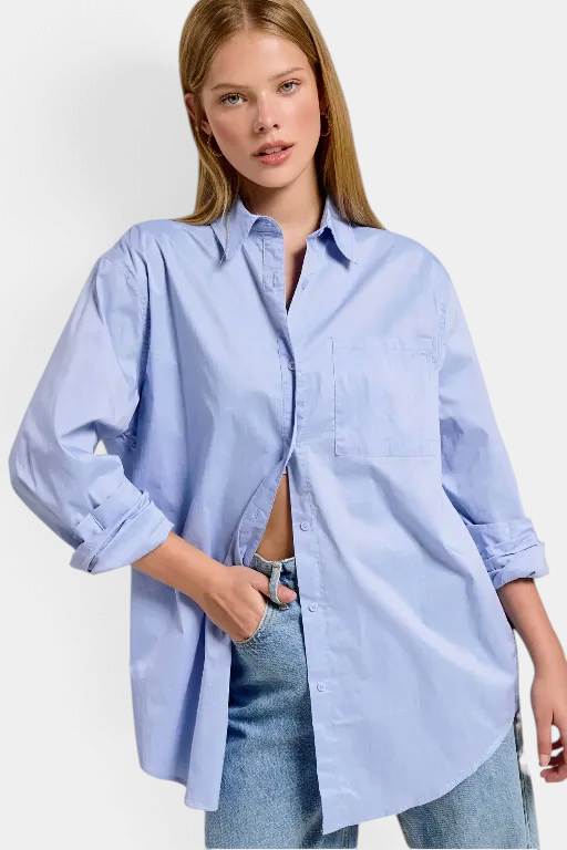 The Copper Shed light blue oversized poplin button-down shirt with a classic collar and front pocket on a model