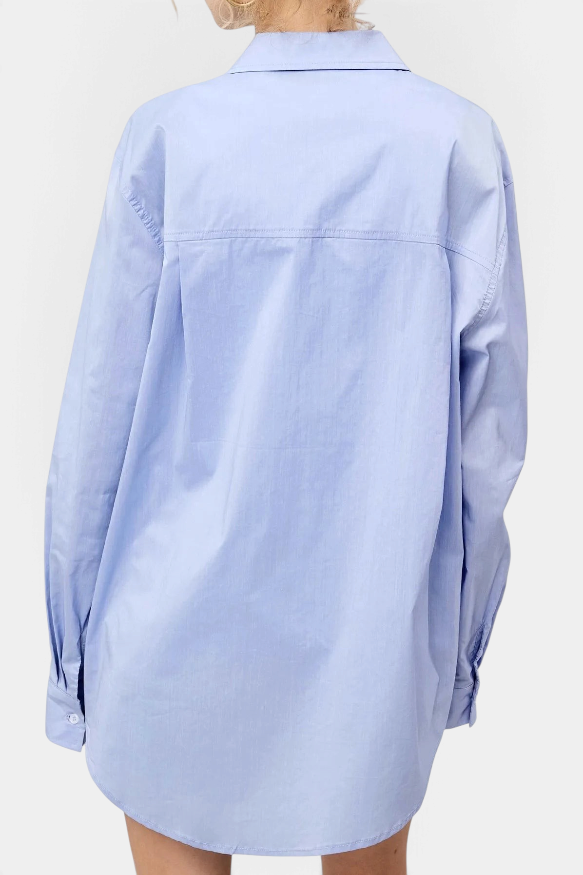 The Copper Shed light blue oversized poplin button-down shirt with a classic collar, back view on a model.