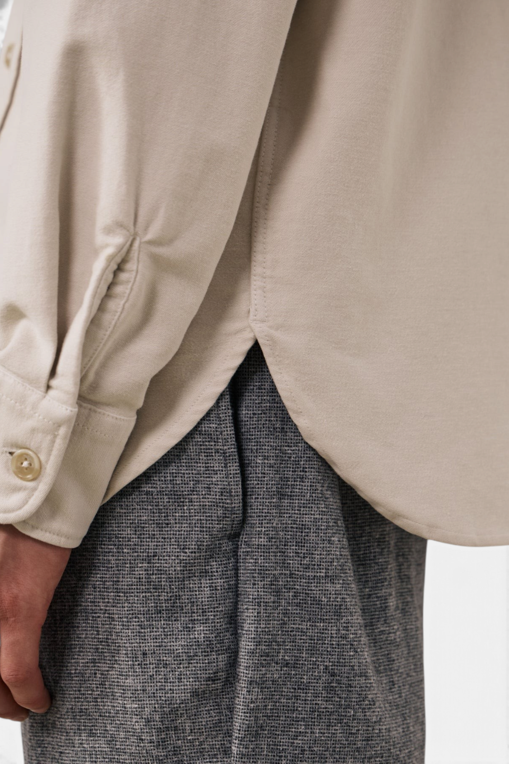 The Copper Shed Paco beige brushed cotton flannel shirt showing the side slit hem and adjustable buttoned cuff detail.