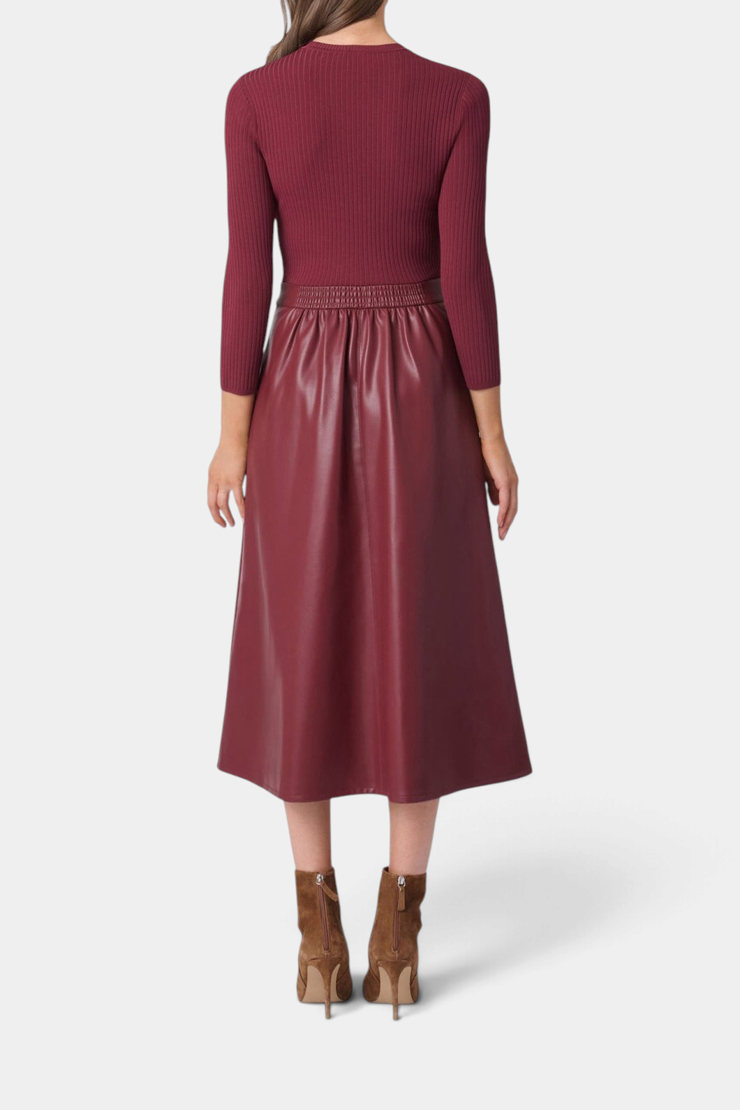 Back view of The Copper Shed Paige midi dress with a burgundy ribbed knit bodice and faux leather A-line skirt.