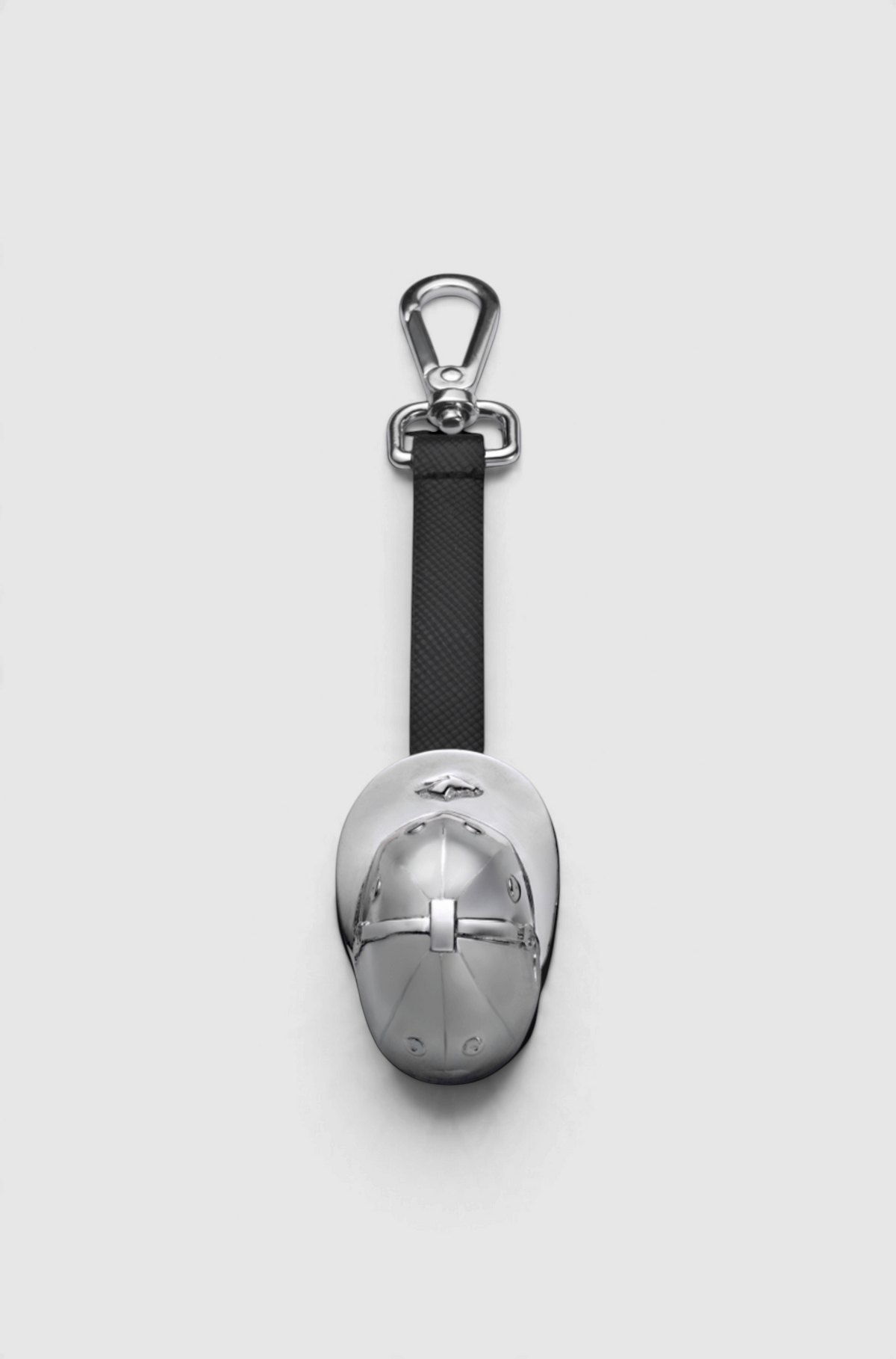 The Copper Shed Casa Libertas Palermo rhodium-plated brass polo helmet keychain with a black strap and silver clasp.