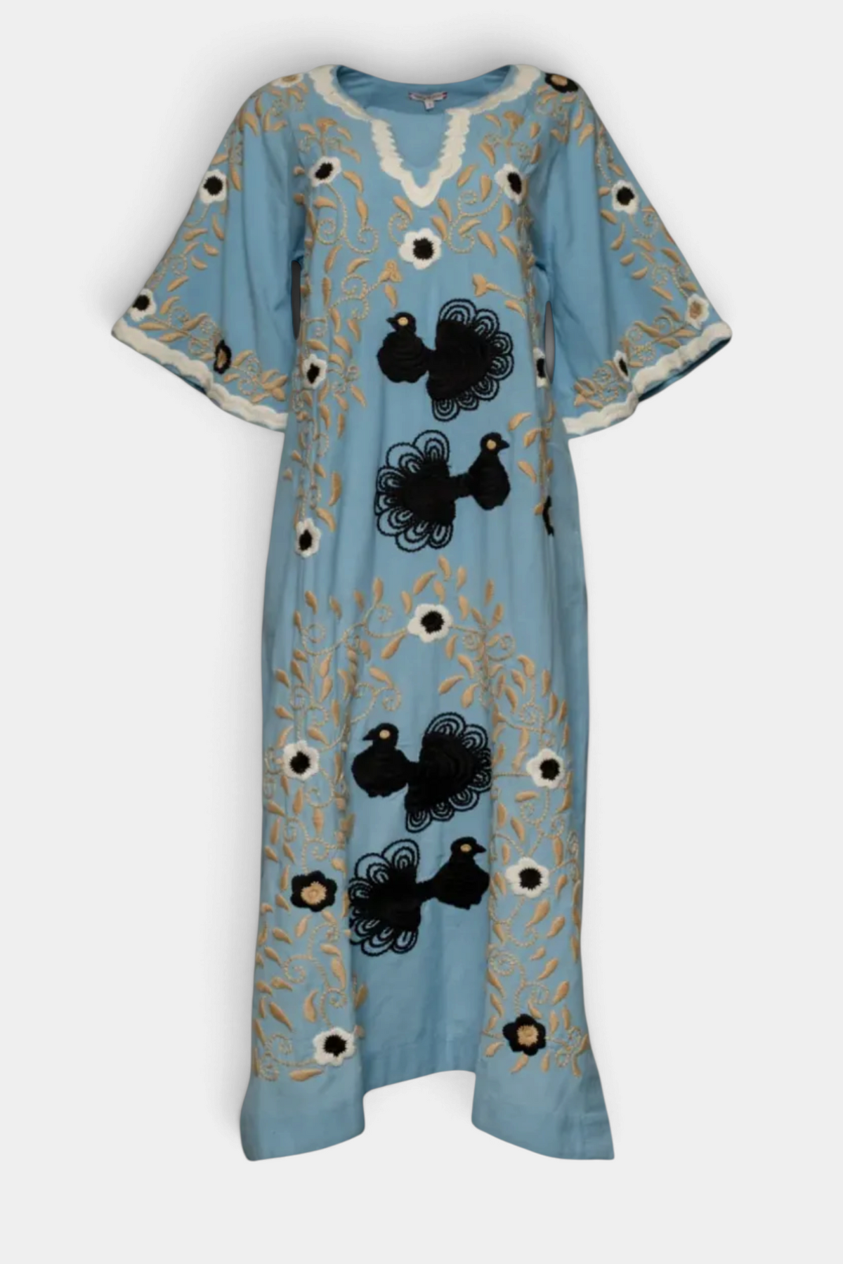 The Copper Shed light blue cotton maxi caftan with black peacock embroidery, bell sleeves, and split scoop neckline.