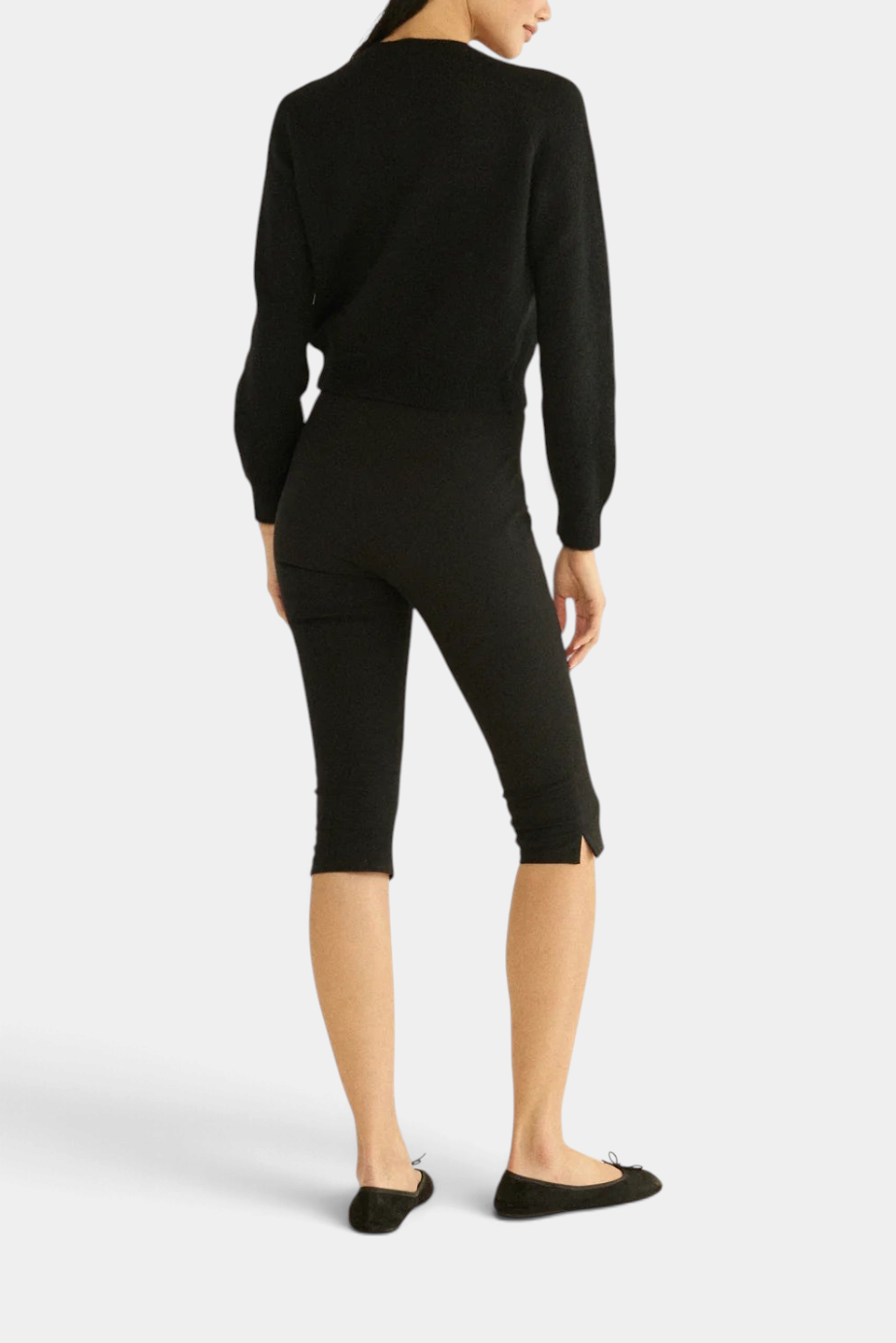 The Copper Shed black cardigan and matching cropped leggings worn by a model, back view.