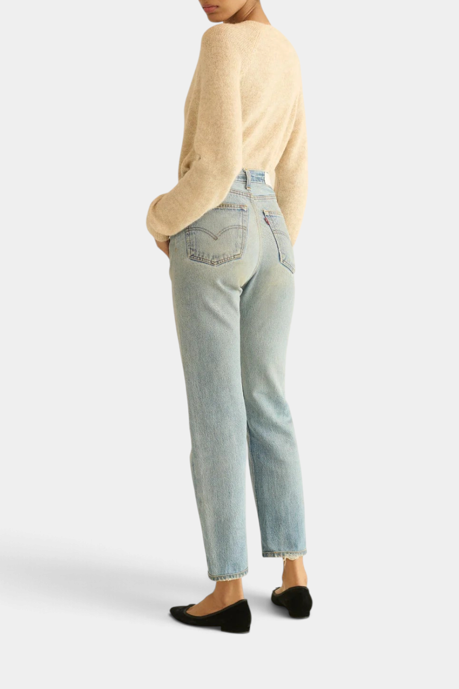 Model wearing The Copper Shed Petra Cardigan in beige alpaca wool blend with light wash denim jeans and black flats