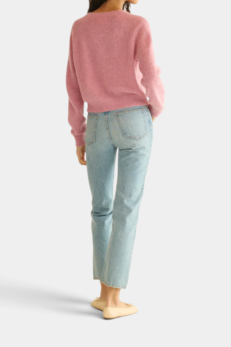 The Copper Shed Petra Cardigan in soft pink alpaca and merino wool blend, shown from the back with light wash jeans.