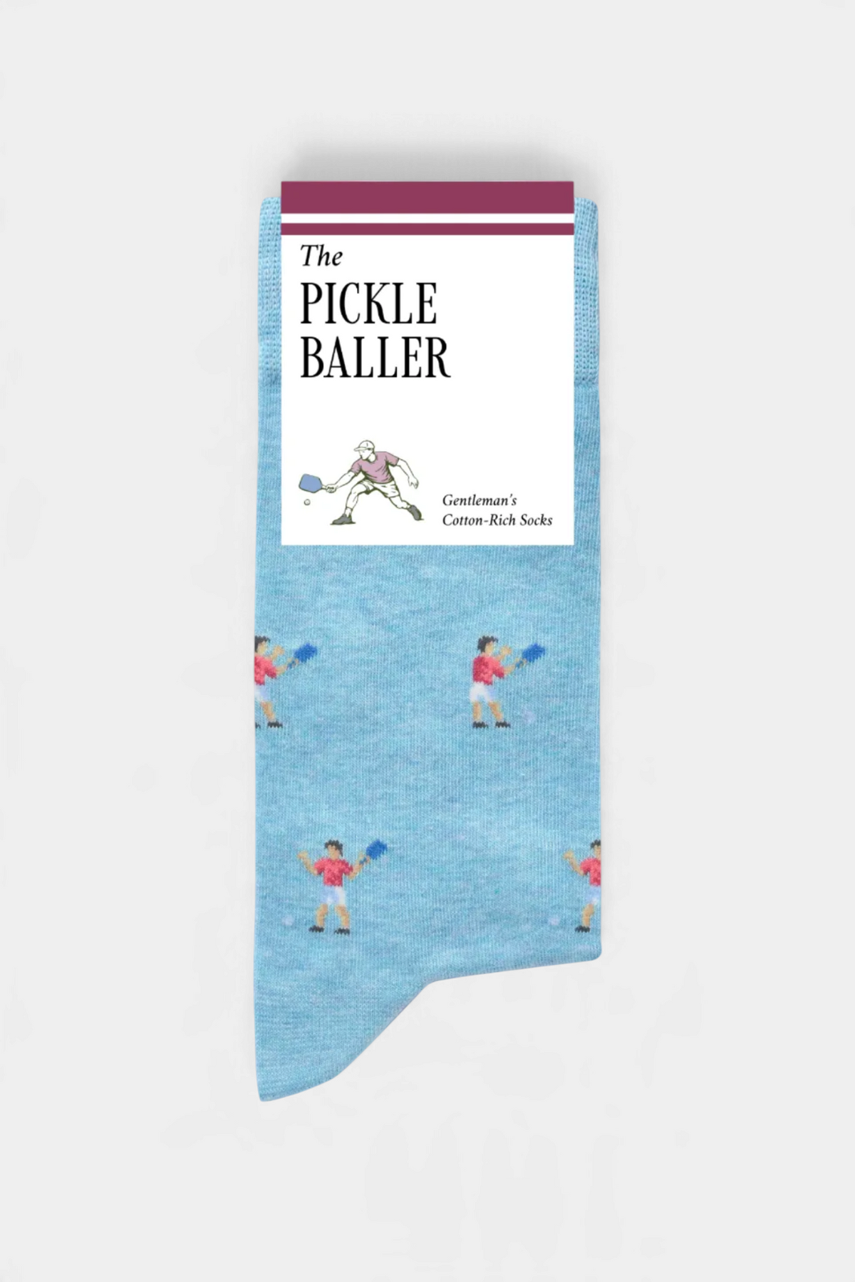 The Copper Shed light blue cotton-rich novelty socks featuring a repeating pickleball player pattern
