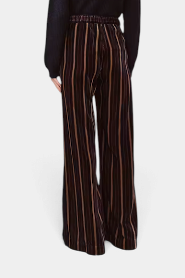 The Copper Shed Piedro trousers in dark striped velvet with a relaxed wide-leg fit and fluid drape, back view.