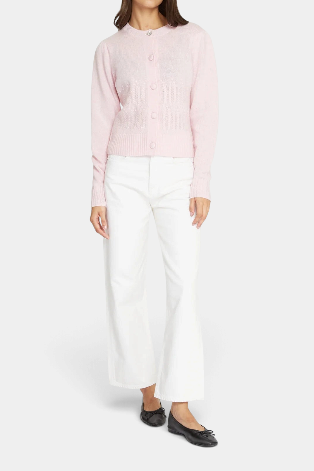 The Copper Shed heather pink cashmere cardigan with puff sleeves, popcorn stitch, and a crystal button, worn by model.
