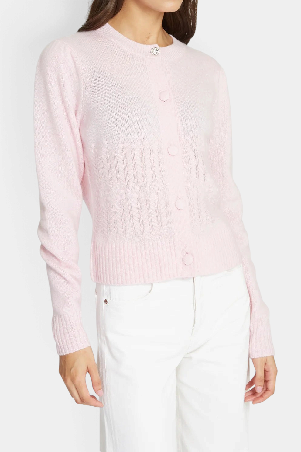 The Copper Shed heather pink cashmere cardigan with popcorn stitch, puff sleeves, and a crystal button at the neck.