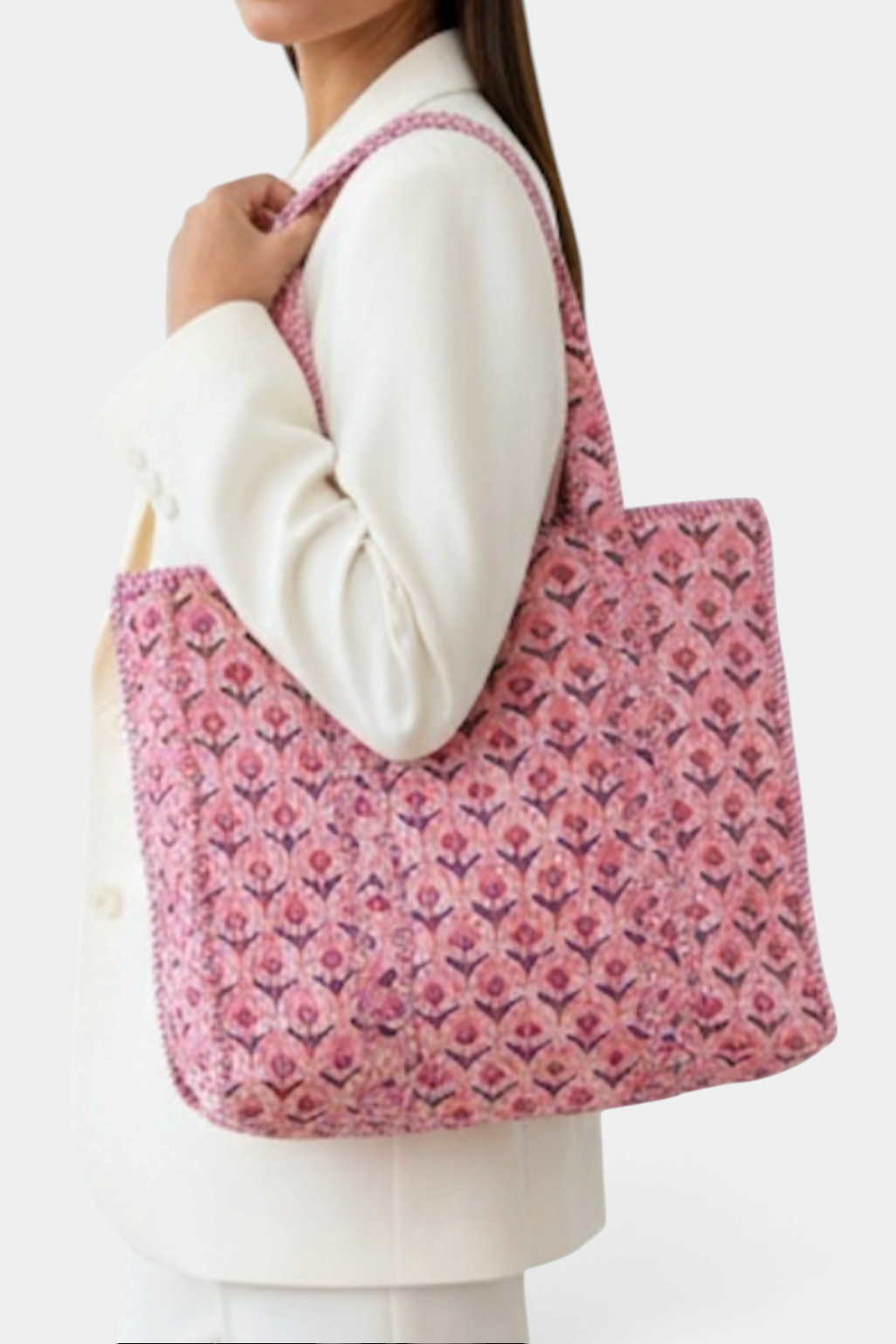 The Copper Shed pink quilted cotton tote bag with floral block print, worn over the shoulder by a model.