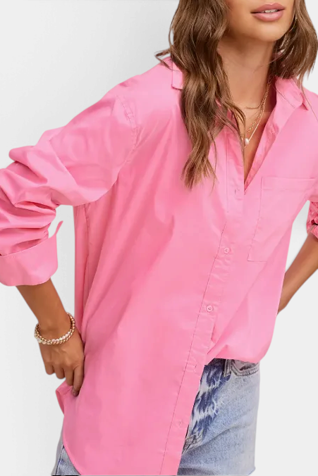 The Copper Shed oversized pink poplin button-down shirt with a classic collar and front pocket on a model