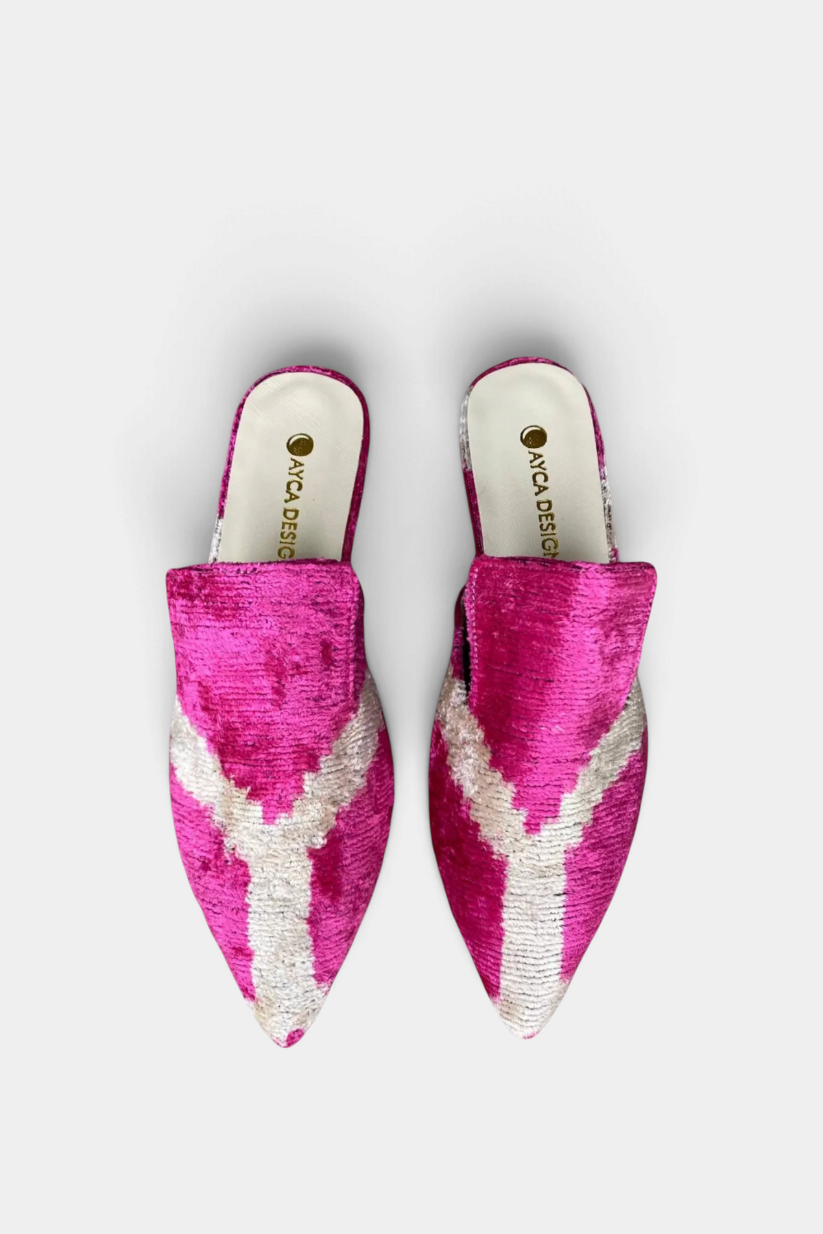 The Copper Shed silk velvet ikat pointed-toe slides in vibrant pink and white, featuring a handcrafted open-back design.
