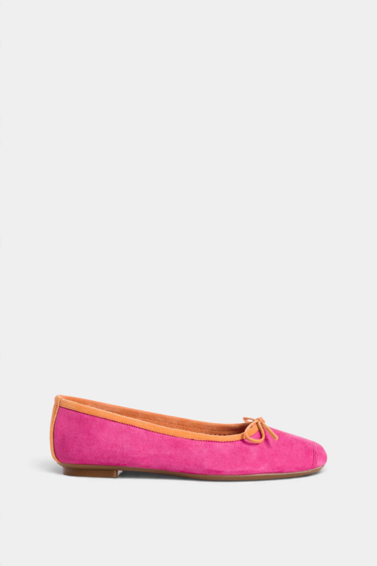 The Copper Shed Harmony suede ballerina flats in vibrant pink with tan trim and a small bow detail