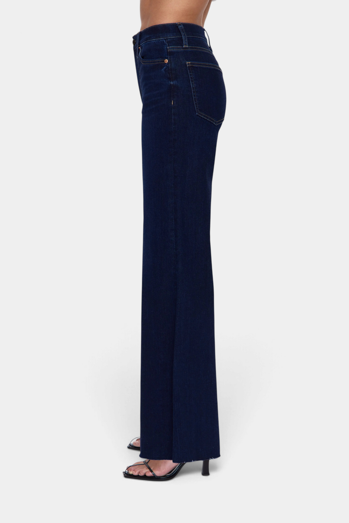 The Copper Shed Pistola Izzy high rise wide leg jeans in dark wash denim worn by a model in profile view.