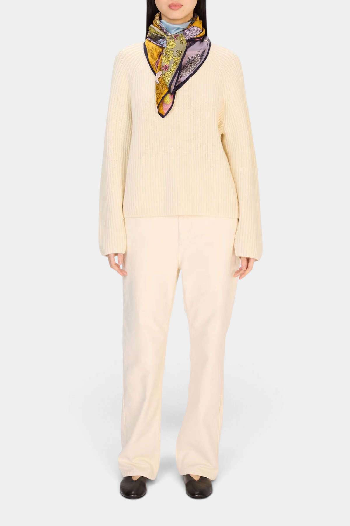 Model wearing The Copper Shed Square 100 Quatre Saisons Pastel silk and modal scarf with a cream sweater and trousers