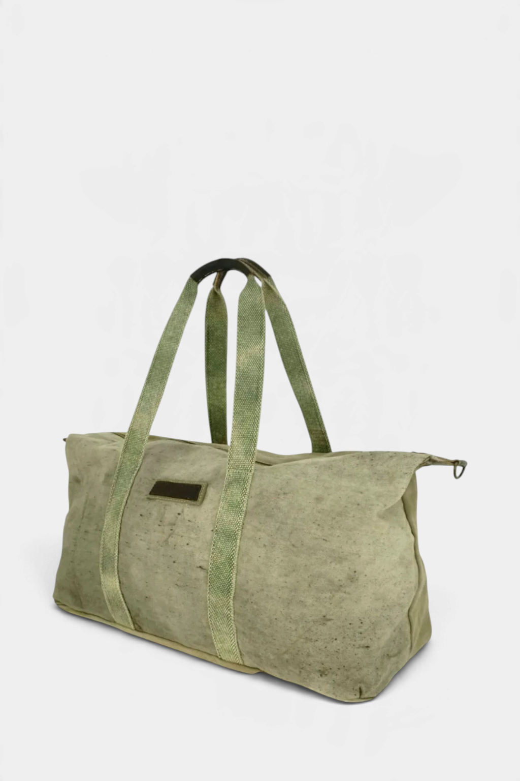 The Copper Shed recycled military tent weekender duffle bag in olive green with leather handles and cotton webbing.