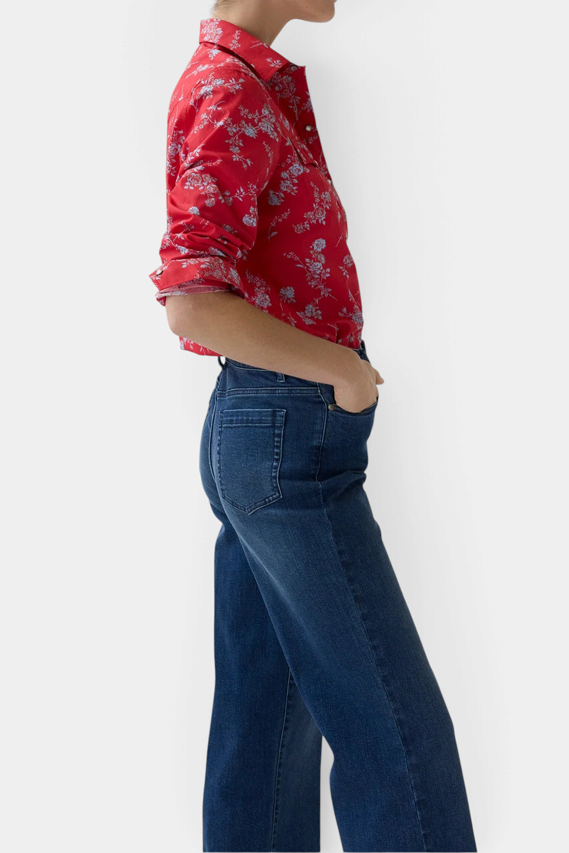 The Copper Shed Western shirt in red Liberty Fabrics floral cotton poplin with pearl snaps, worn with blue jeans.