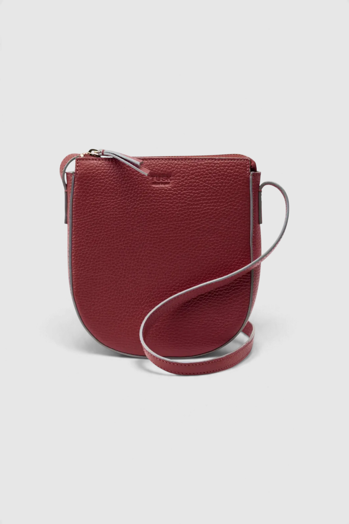 The Copper Shed Yash small crossbody bag in red Italian pebble grain leather with a sleek zip closure.