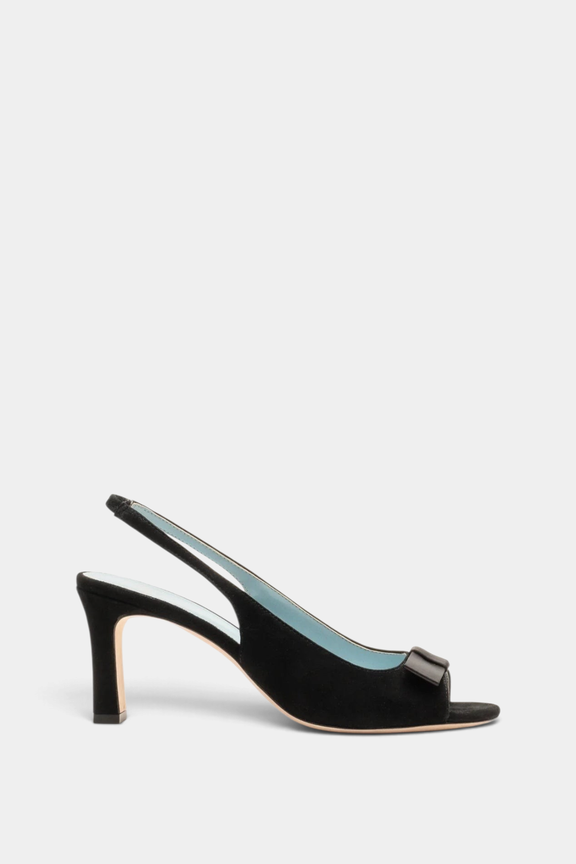 The Copper Shed Reese black suede slingback heel with an open toe, ankle strap, and elegant bow detail on the vamp.