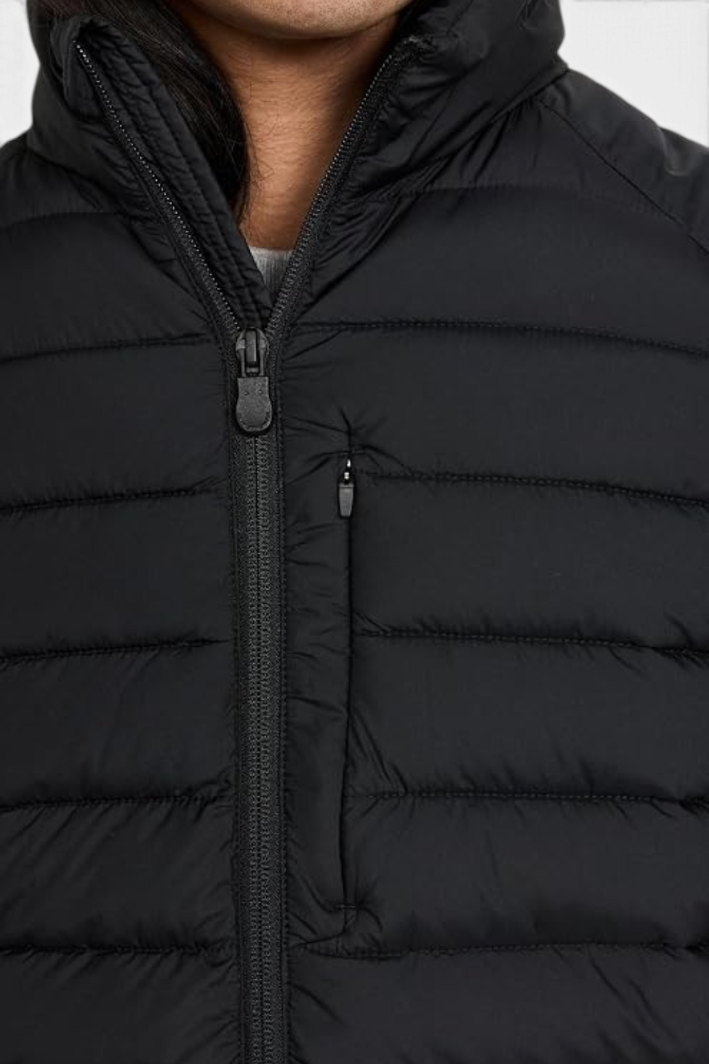 The Copper Shed Rhus black quilted puffer vest with stand-up collar, two-way zipper, and chest pocket detail.
