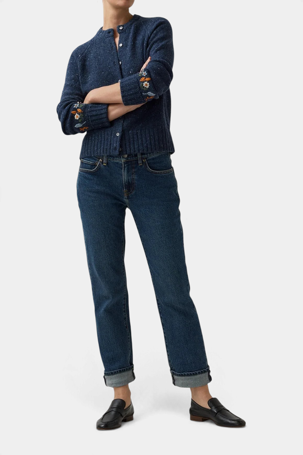 The Copper Shed Romy navy blue wool-alpaca cardigan with floral embroidery on cuffs worn with cuffed jeans