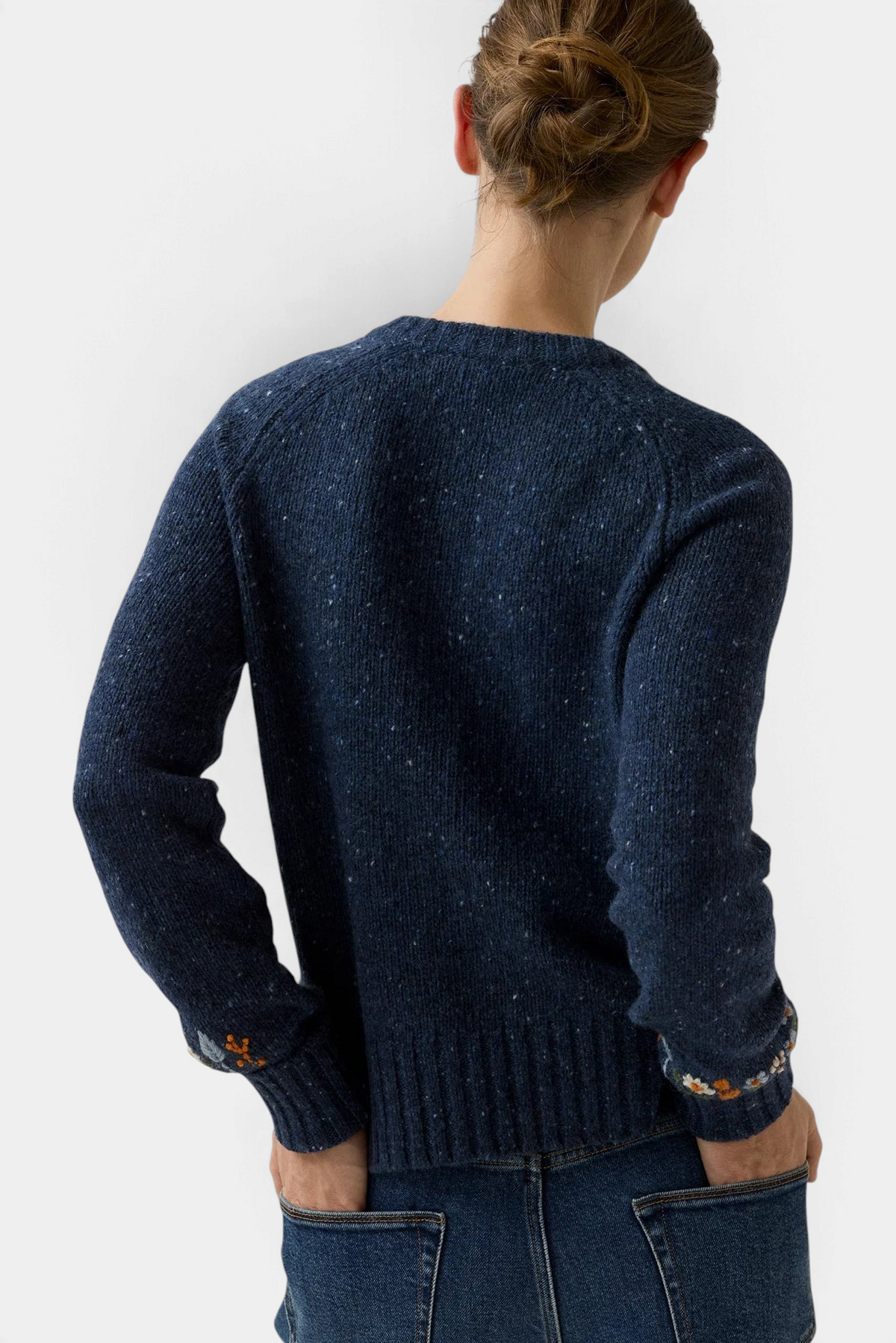 The Copper Shed Romy navy blue donegal wool and alpaca cardigan with floral embroidery on the cuffs, back view