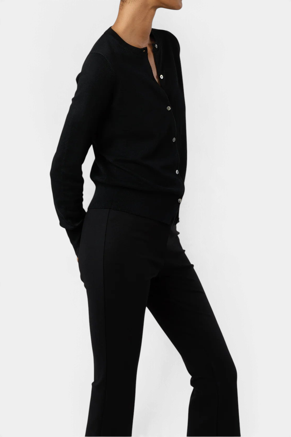 The Copper Shed Rosie black cotton-silk cardigan with mother-of-pearl buttons worn as a fitted top