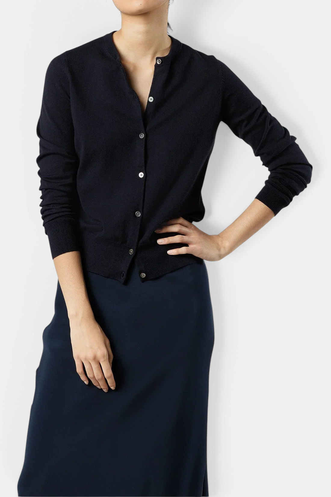 The Copper Shed Rosie cardigan in navy blue cotton-silk knit with a jewel neckline and smoke mother-of-pearl buttons.