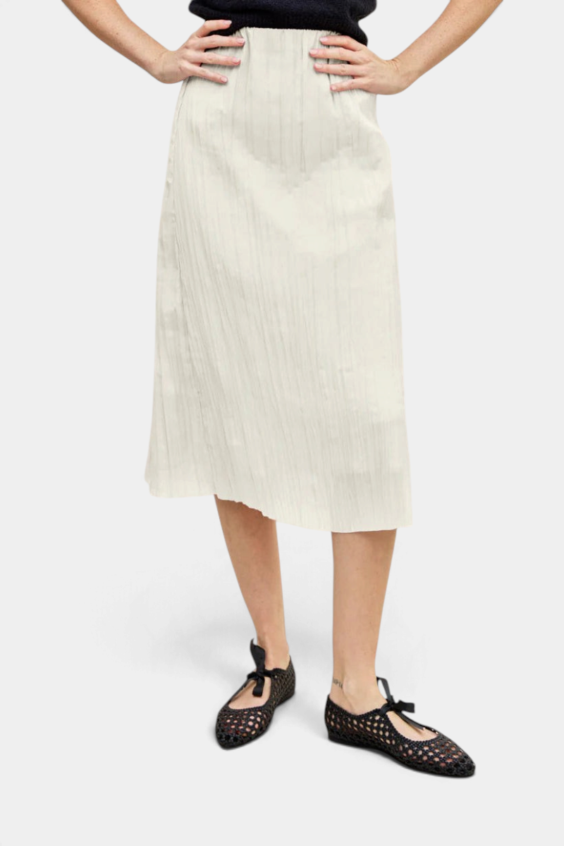 The Copper Shed Sabi midi skirt in off-white crinkle-pleated Japanese fabric with an elastic pull-on waistband.