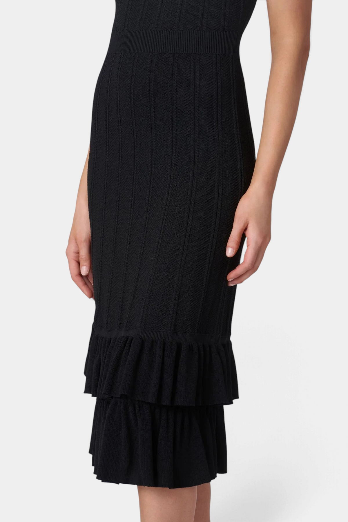 The Copper Shed Savannah midi dress in black featuring a delicate pointelle knit texture and tiered ruffle hem.