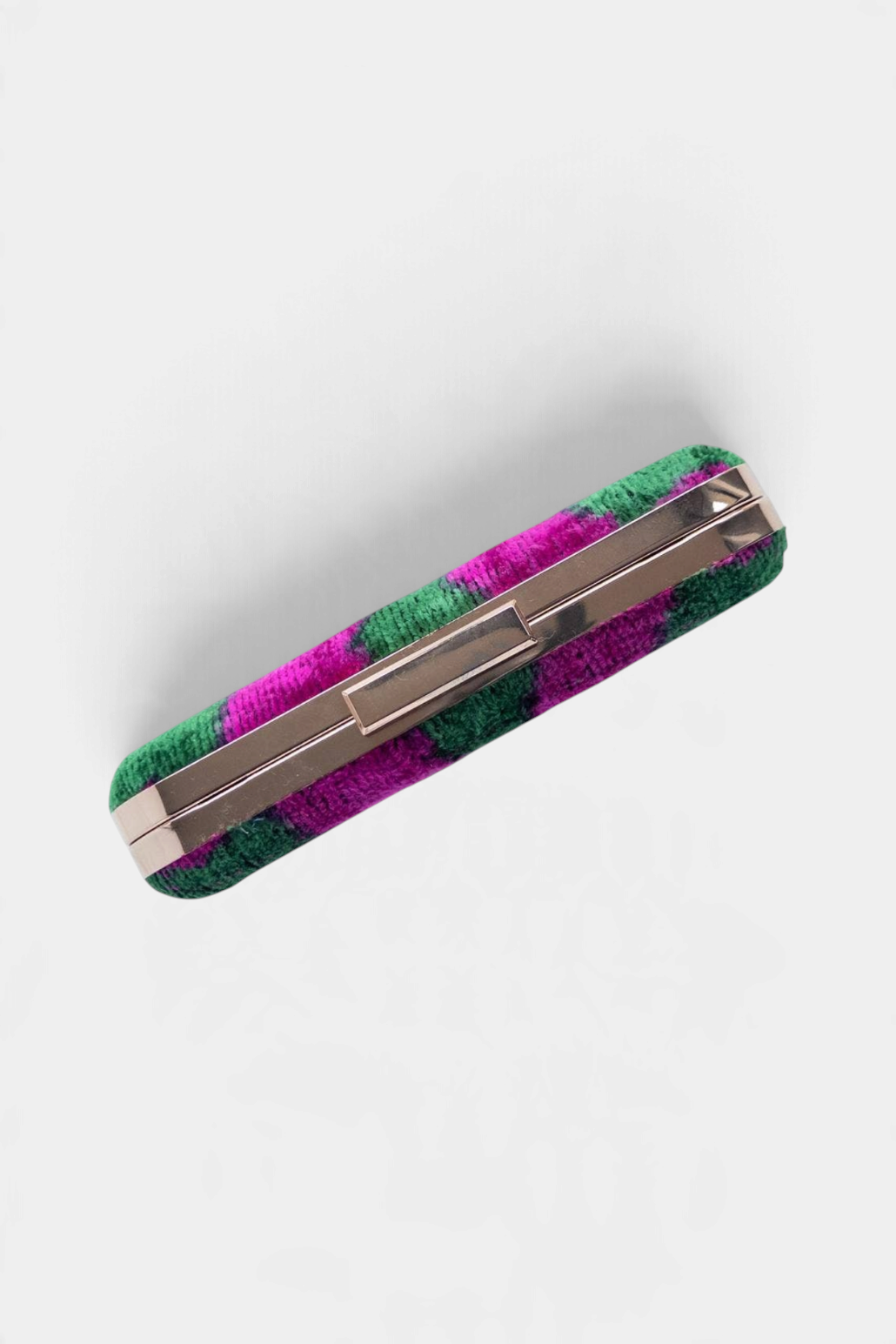 The Copper Shed silk velvet ikat box clutch in green and magenta with a metallic frame closure.