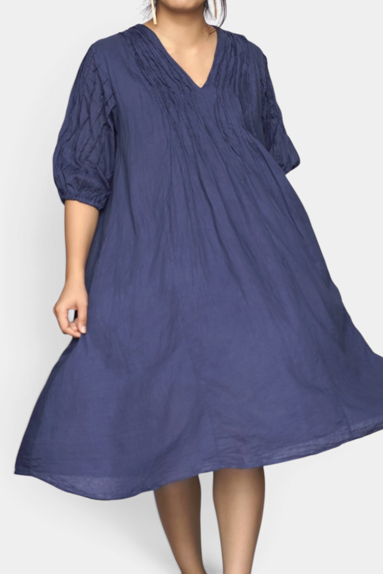 The Copper Shed Dolma Skye midi dress in petrol blue cotton with 3/4 sleeves and delicate front pleating.