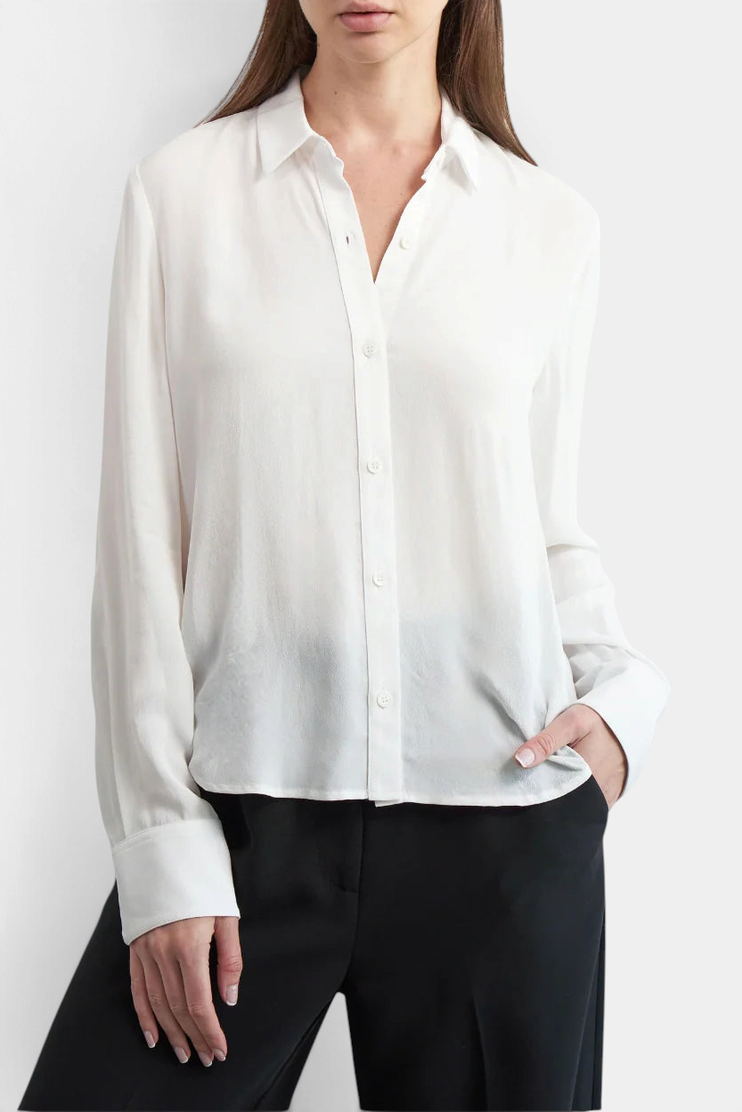 The Copper Shed Stacey blouse in white rayon crepe with a classic collar, button cuffs, and elegant draped fit.