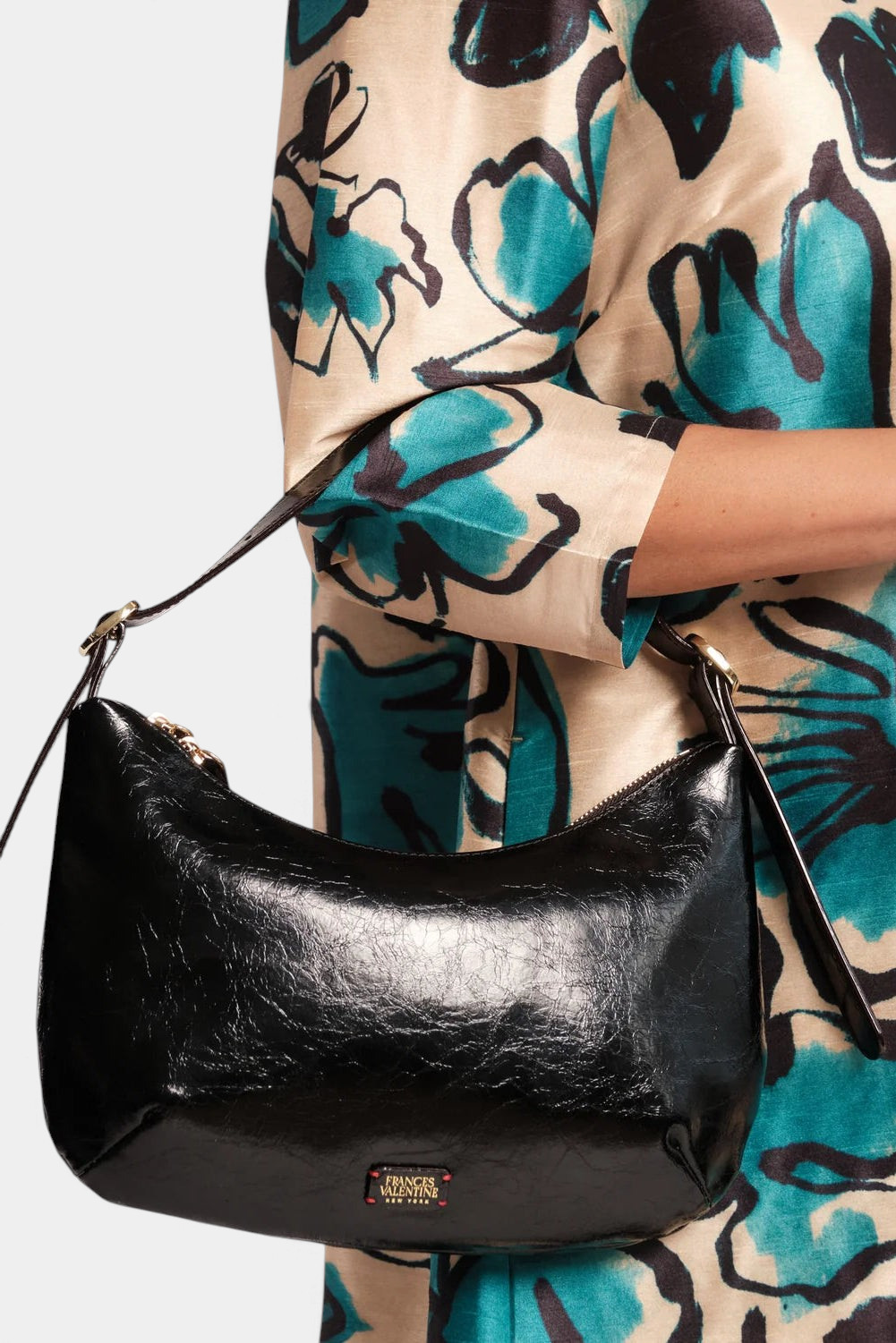 The Copper Shed Starr hobo bag in black crinkled leather with a slim shoulder strap worn under the arm