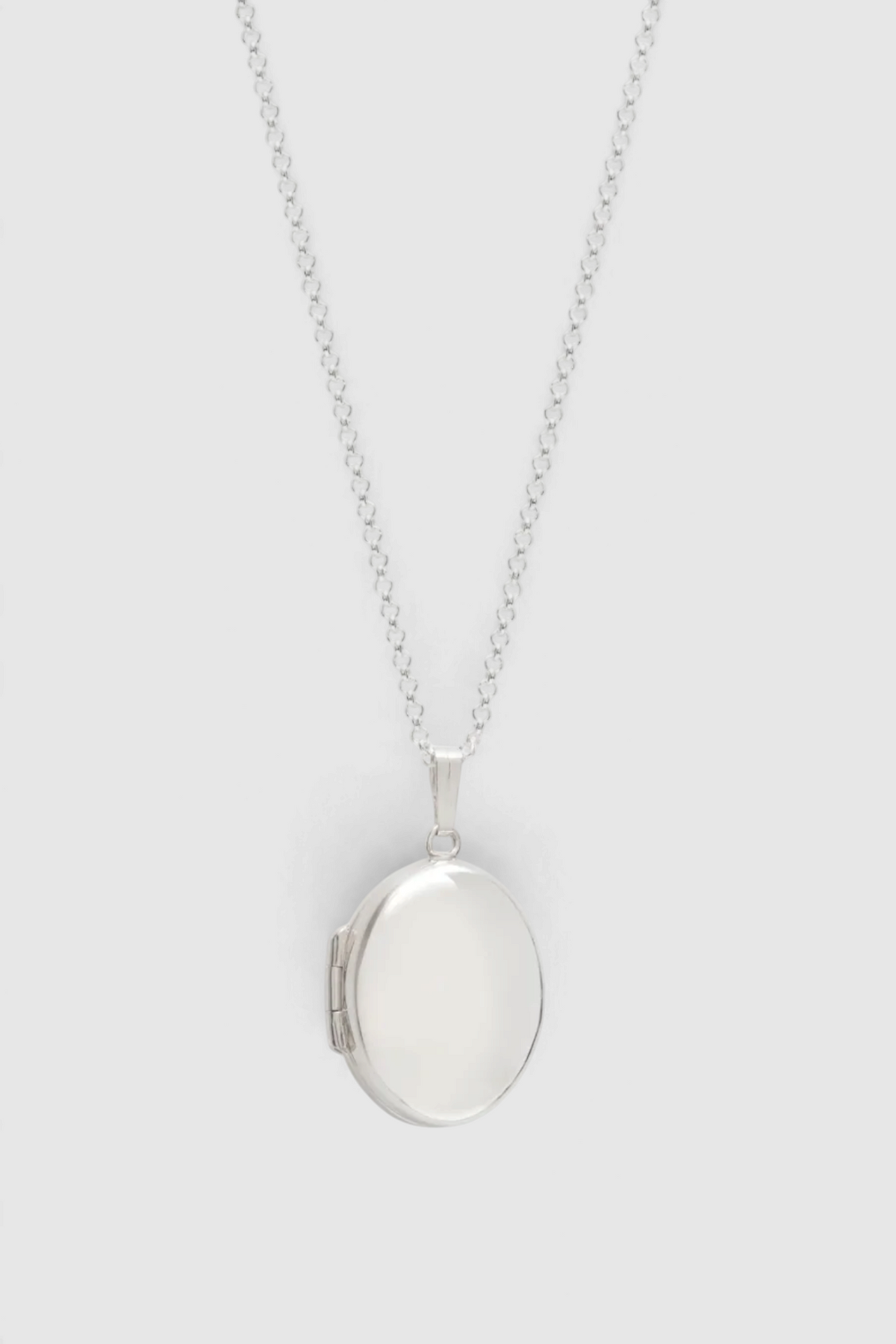 The Copper Shed sterling silver oval locket necklace with a polished finish and delicate chain.