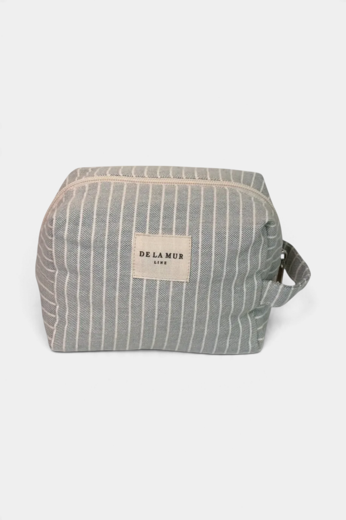 The Copper Shed medium squared makeup bag in grey and white striped woven fabric with a side handle and zip closure.