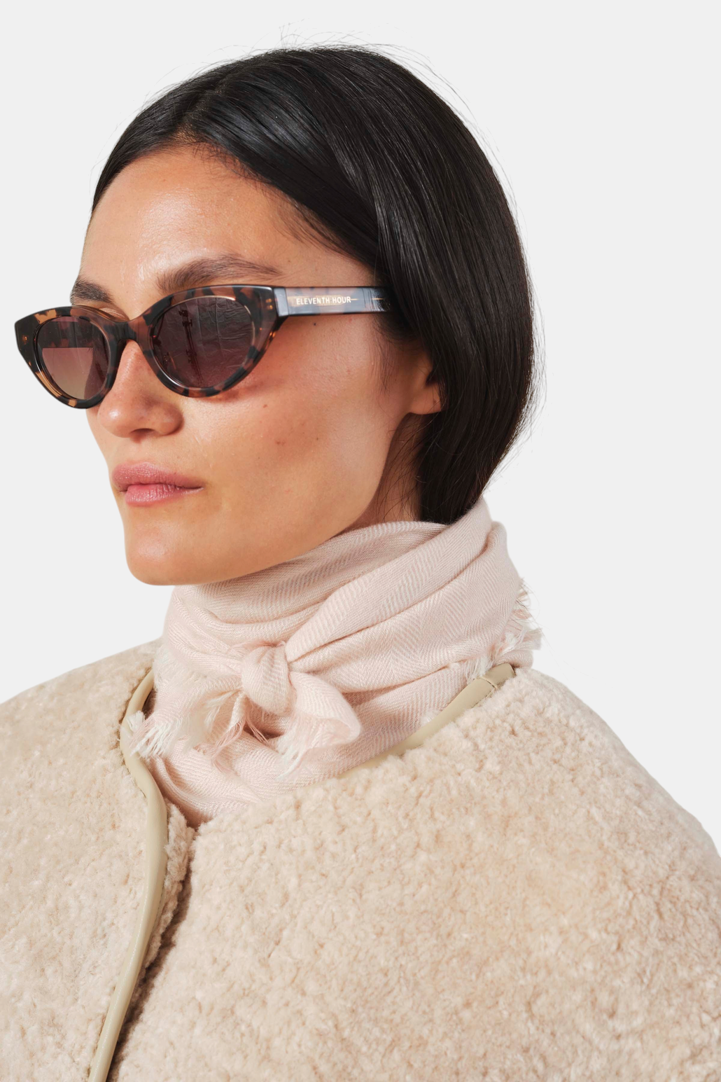 The Copper Shed Summer08 light pink cashmere scarf with a herringbone pattern and frayed edges worn around the neck.
