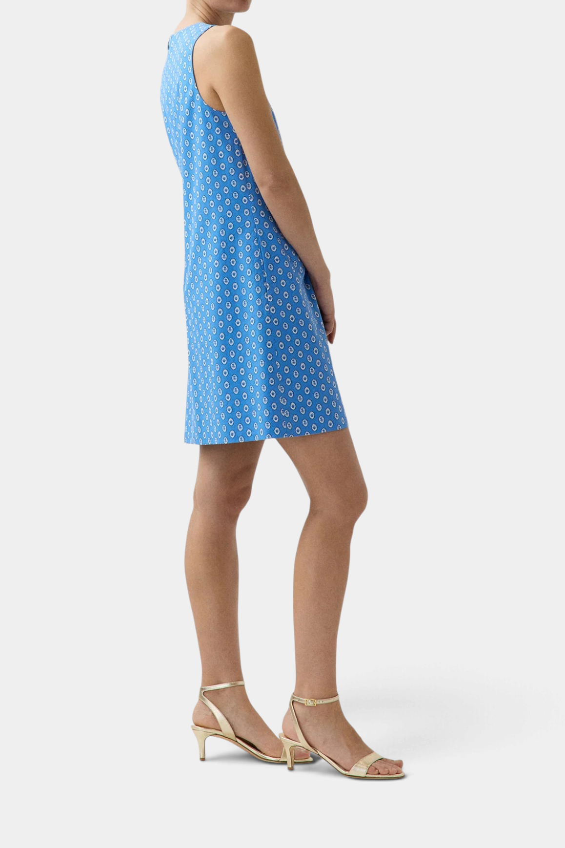 The Copper Shed Susy shift dress in blue cotton poplin with a white floral print, featuring an A-line silhouette.