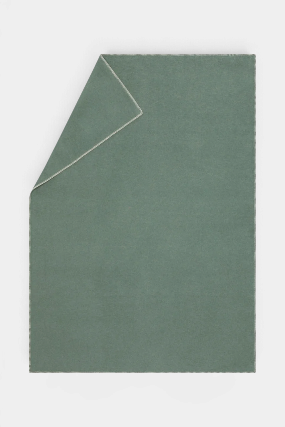 The Copper Shed SYLT sage green recycled cotton blanket with decorative stitched edges for a cozy home aesthetic.