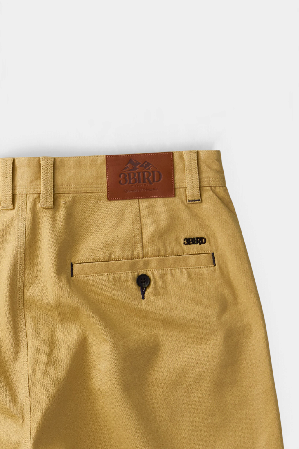 The Copper Shed Breakout Broken Twill Short in tan organic cotton with a rear welt pocket and leather brand patch.