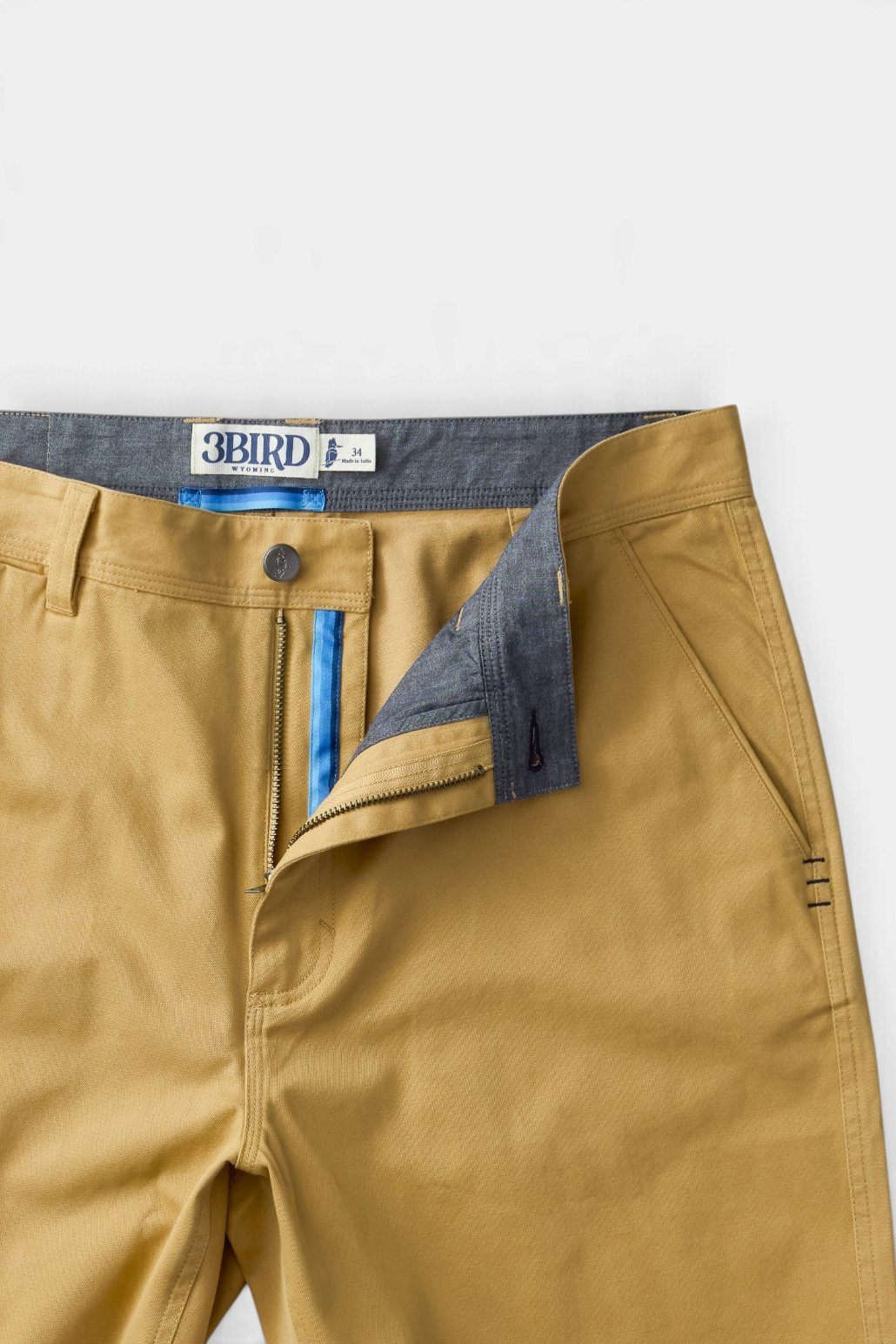 The Copper Shed Breakout broken twill shorts in tan organic cotton with blue interior detailing and YKK zipper fly.