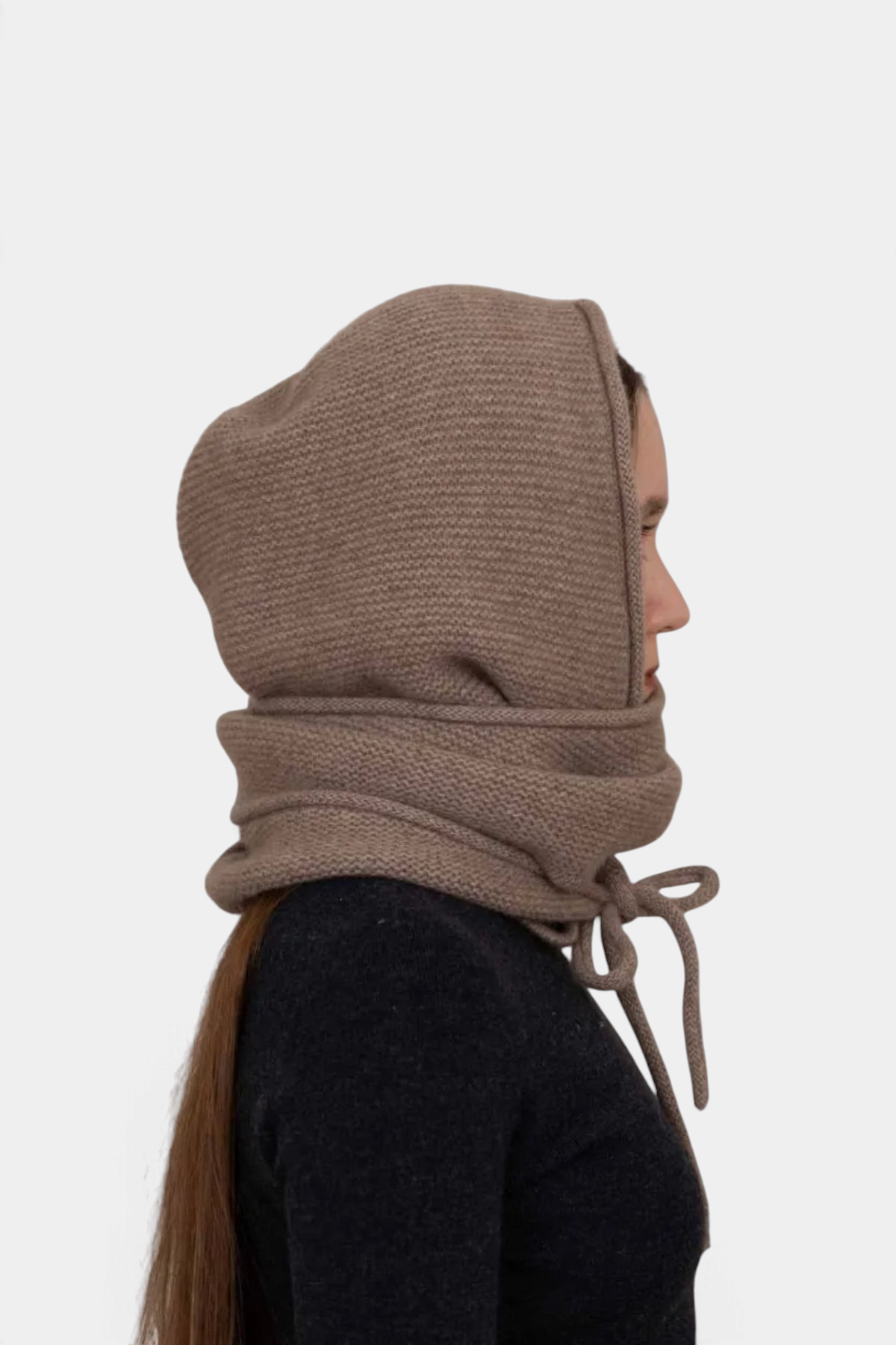The Copper Shed Eden hooded scarf in taupe organic cashmere worn by a model in profile view with tie detail