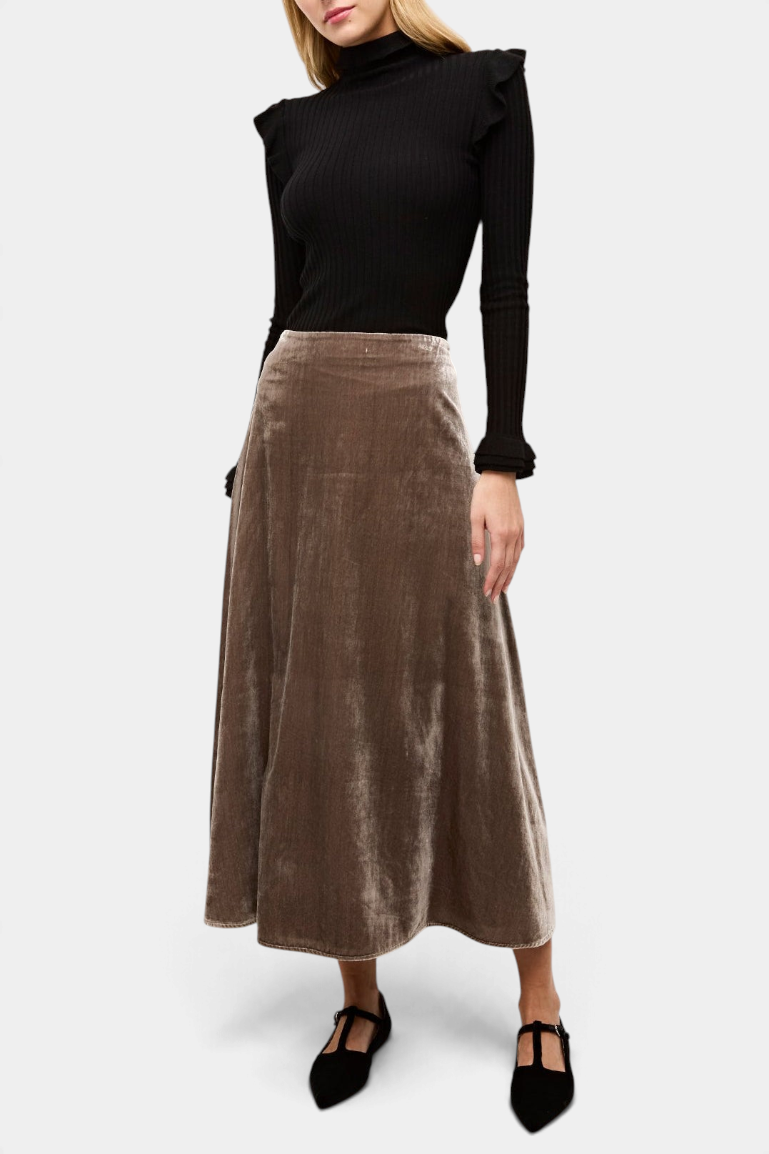 The Copper Shed Tinley black ribbed turtleneck sweater with ruffle trim on the shoulders and cuffs.