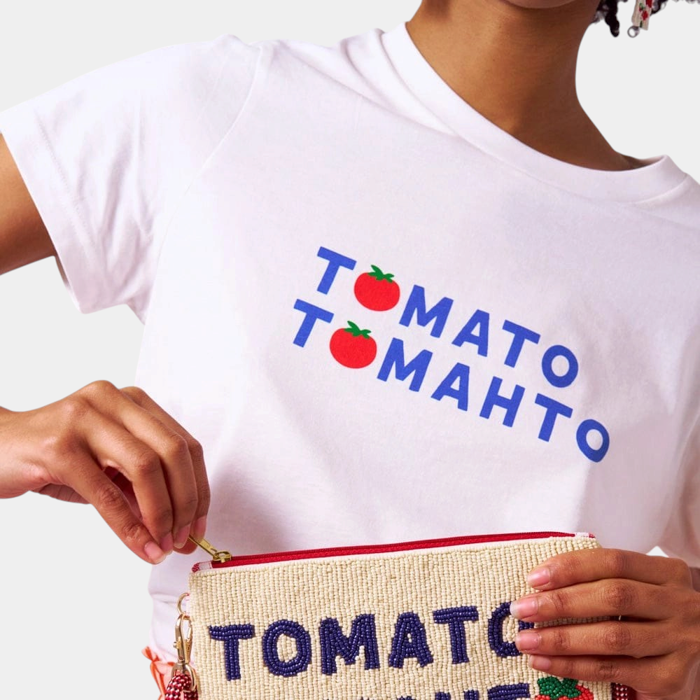 The Copper Shed white graphic t-shirt featuring a red tomato print and blue text saying Tomato Tomahto