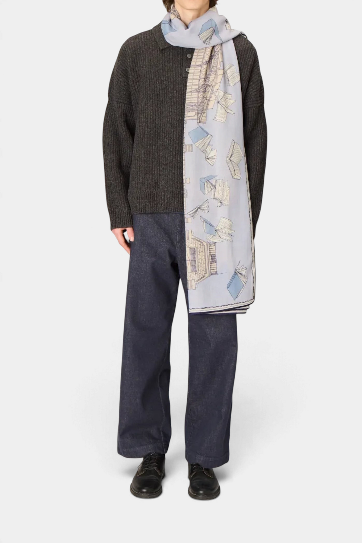 The Copper Shed Vivienne grey wool scarf featuring a whimsical book and building print worn by a model