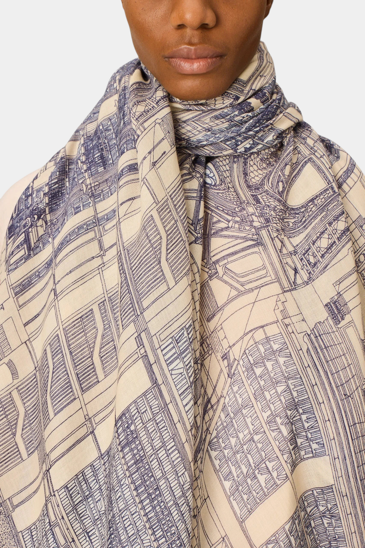 The Copper Shed Vivienne grey wool scarf featuring a detailed architectural line art print worn around the neck.