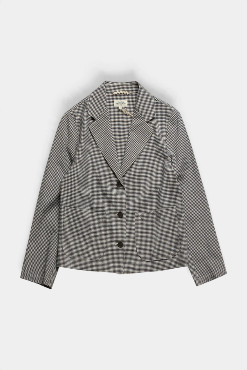 The Copper Shed Vizir jacket in a black and white gingham check with a three-button placket and two patch pockets.