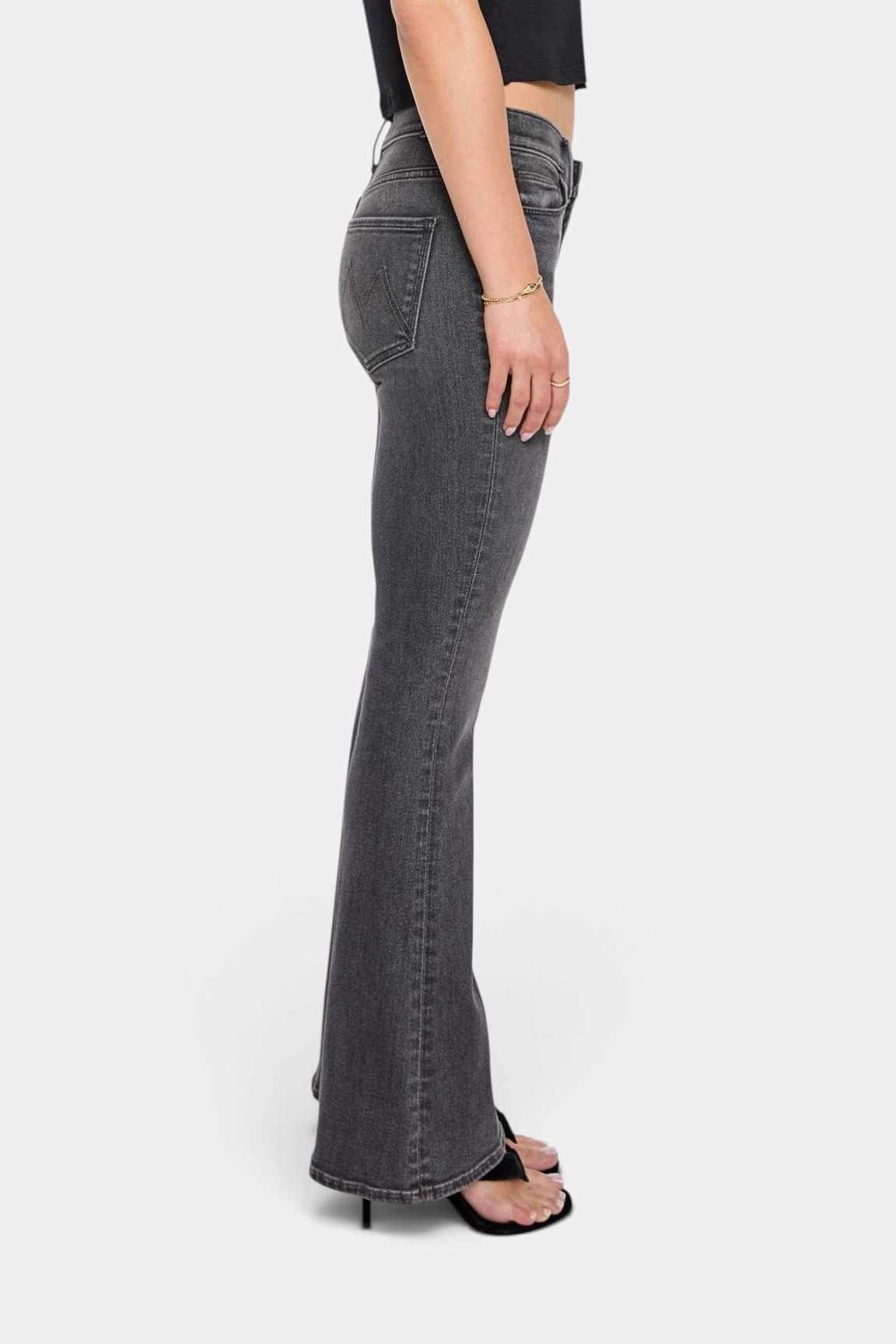 The Copper Shed The Weekender mid-rise flare jeans in washed black denim, side view on a model.