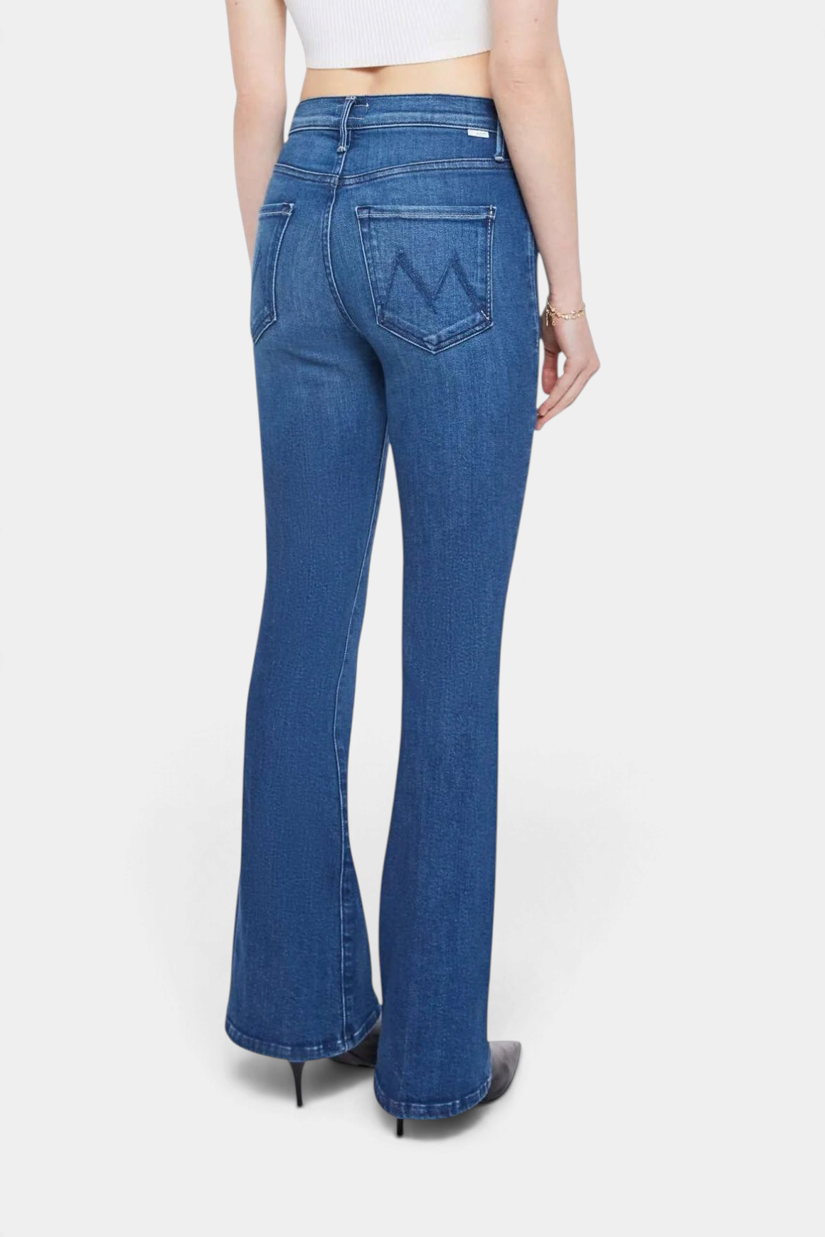 The Copper Shed The Weekender mid-rise flare jeans in medium blue denim with a clean hem, back view.