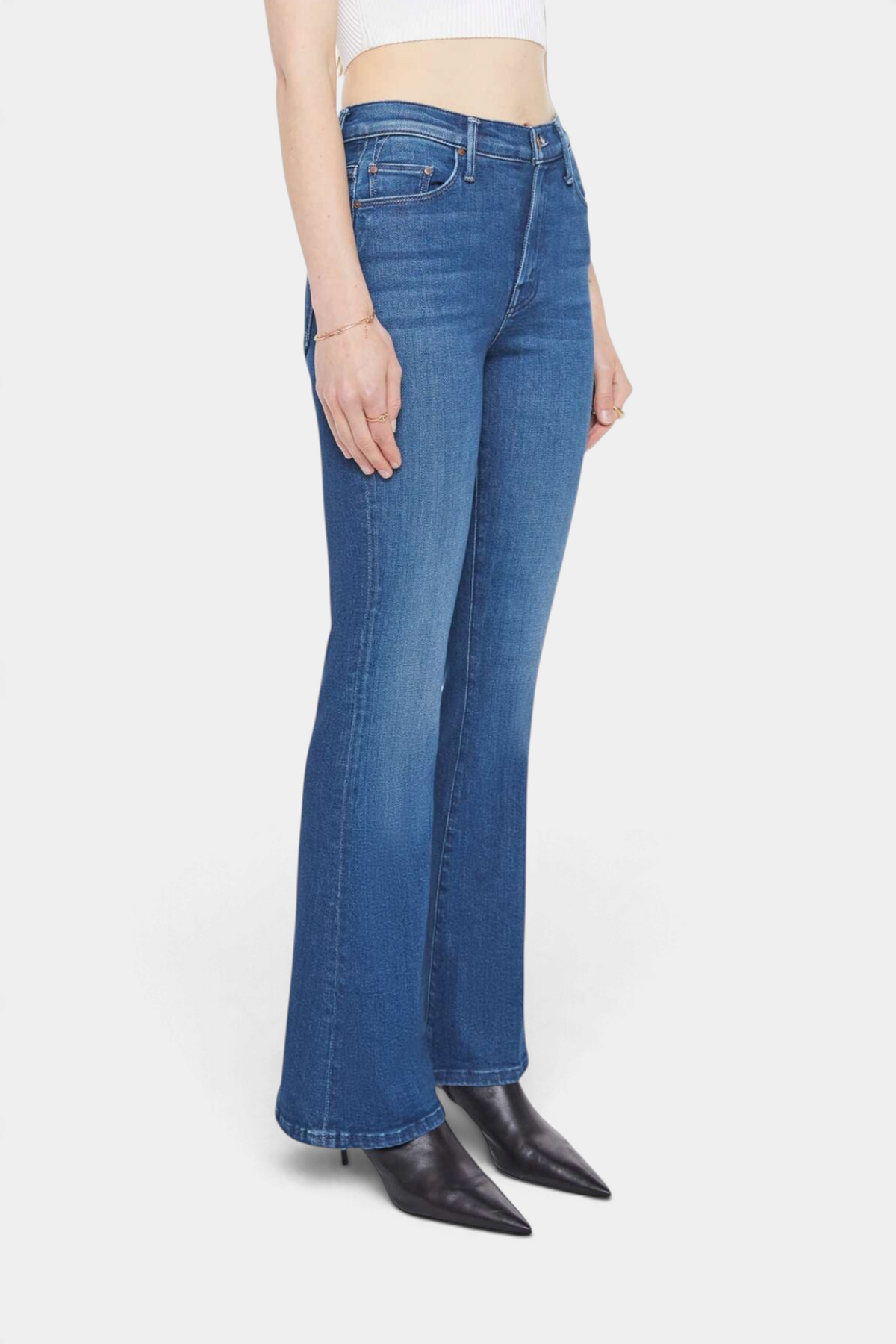 The Copper Shed The Weekender mid-rise flare jeans in medium blue denim with a clean hem, side view on a model.